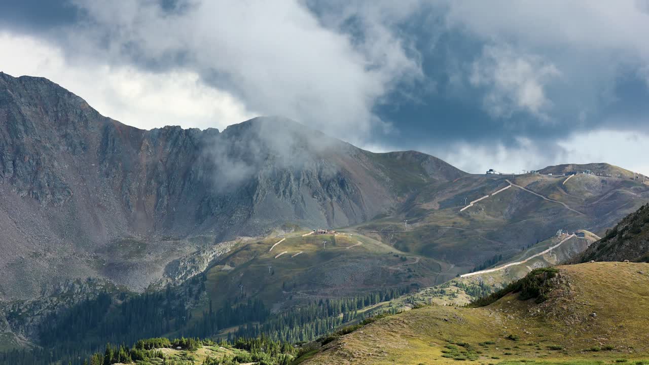Clouds swirl over Rocky Mountains - 4k Time lapse