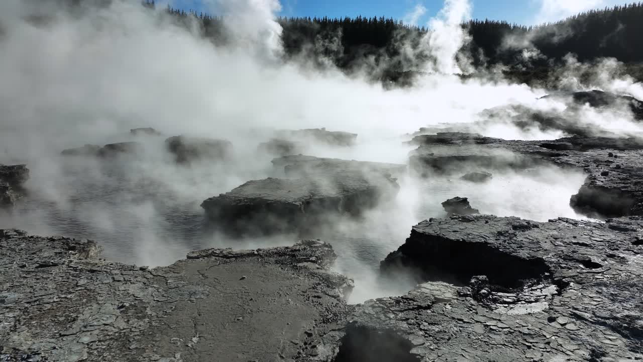 Boiling mud bubbling in steaming landscape, Drone slowly flying over geothermal landscape. Trees, steam, bubbling mud and steam. Alien Landscape. Sci-fi. Global Warming