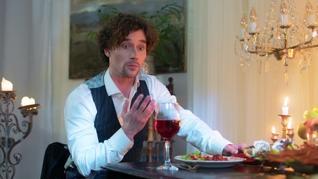 Handsome Man Speaking and Gesturing During a Formal Dinner