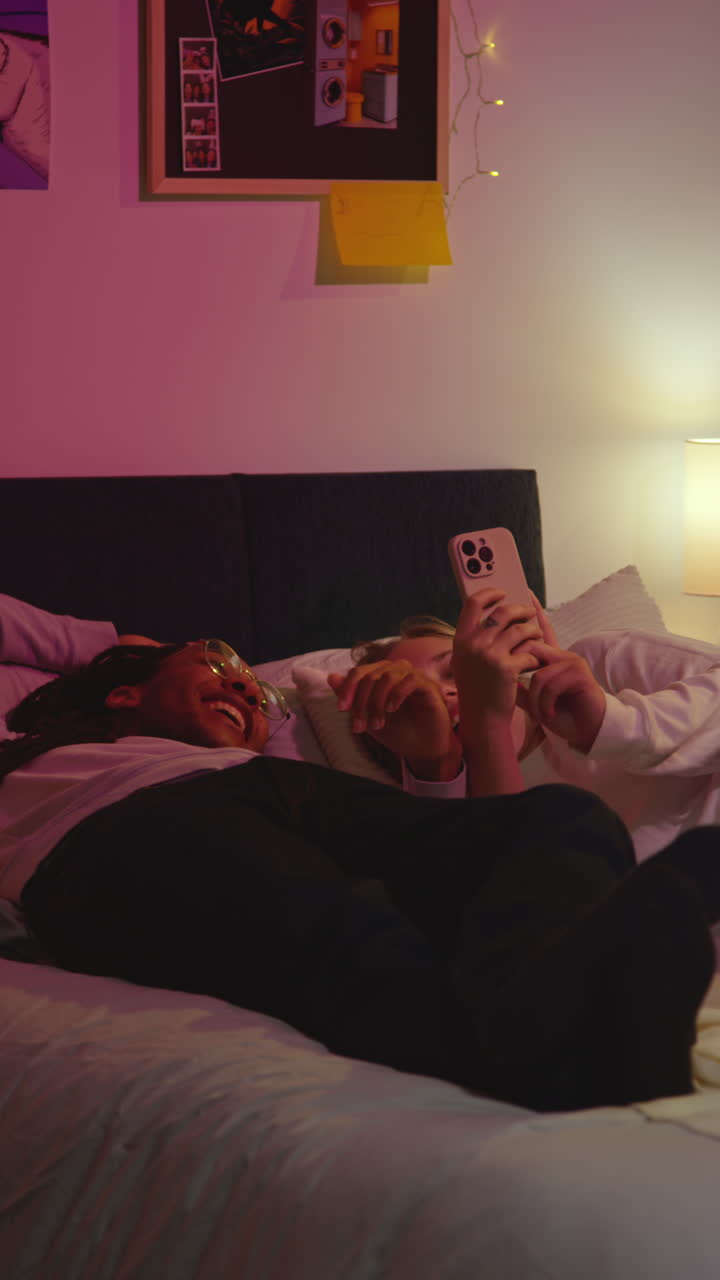 Couple laughing together on a bed