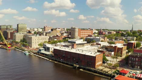 drone pedestal up over buildings on waterfront of wilmington, north carolina