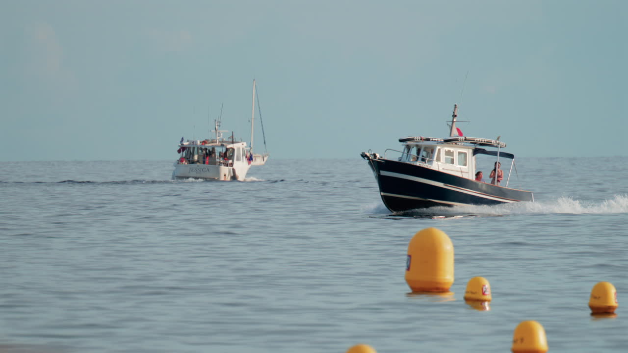 Cannes, France - October 9, 2025: A small motorboat moves steadily over calm blue waters on a clear day