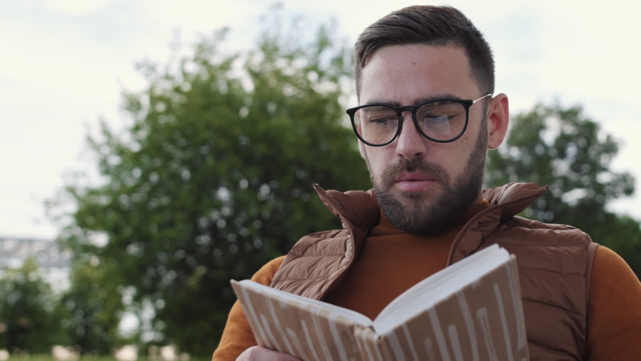 Man Reading and Drinking Coffee Outdoors