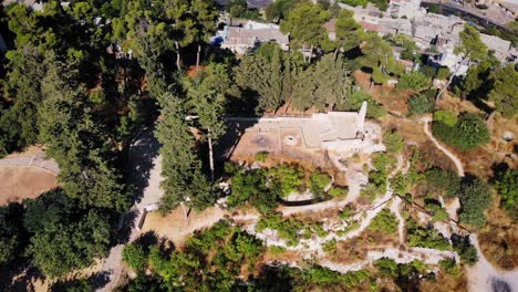 aerial view of a park or memorial site with stone structures and lush greenery
