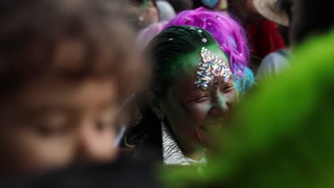 masquerade asian woman and other women and men staying in a group and talking and laughing