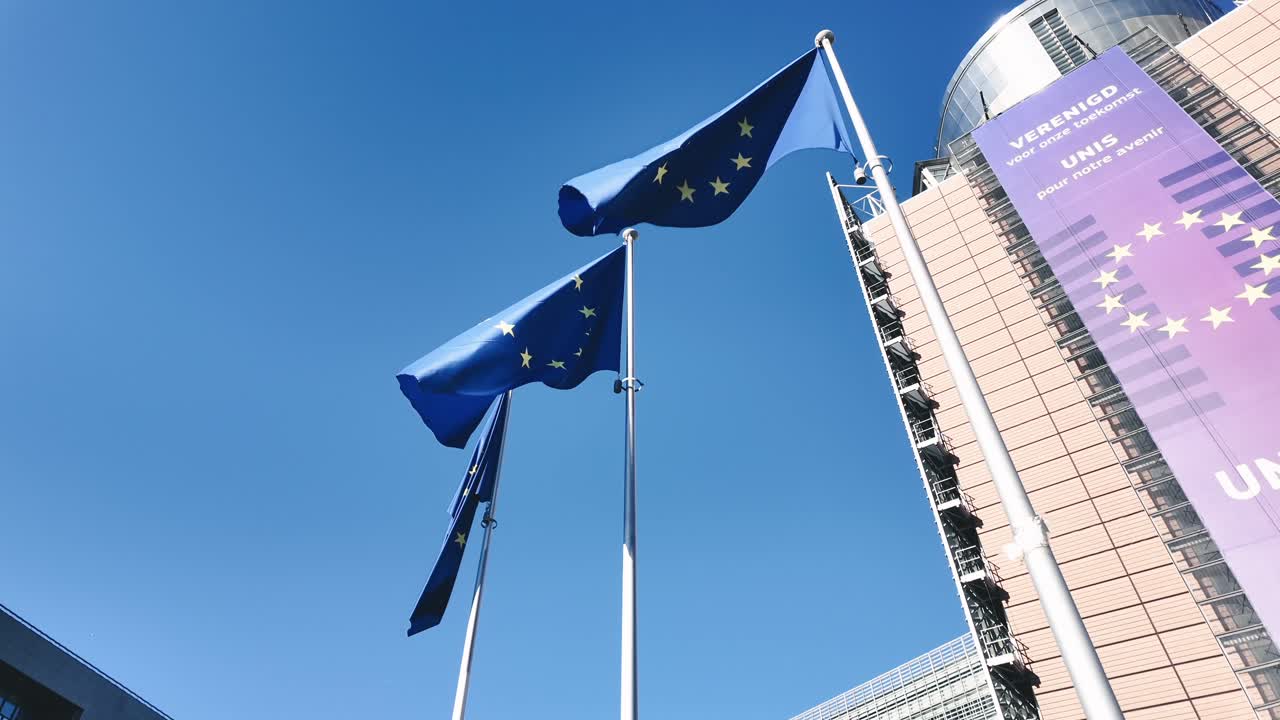 European Union flags waving outside the Berlaymont building in Brussels