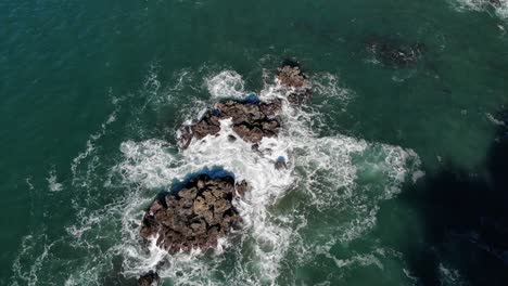 Drohne-Fliegt-über-Wellen,-Die-Gegen-Felsen-Im-Ozean-Prallen