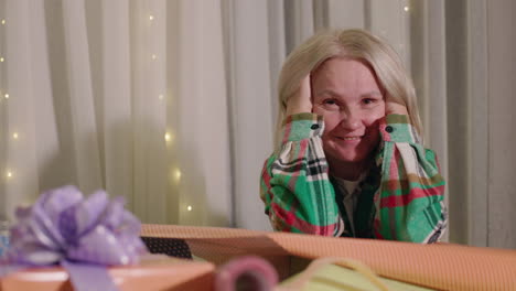 woman wrapping christmas gifts