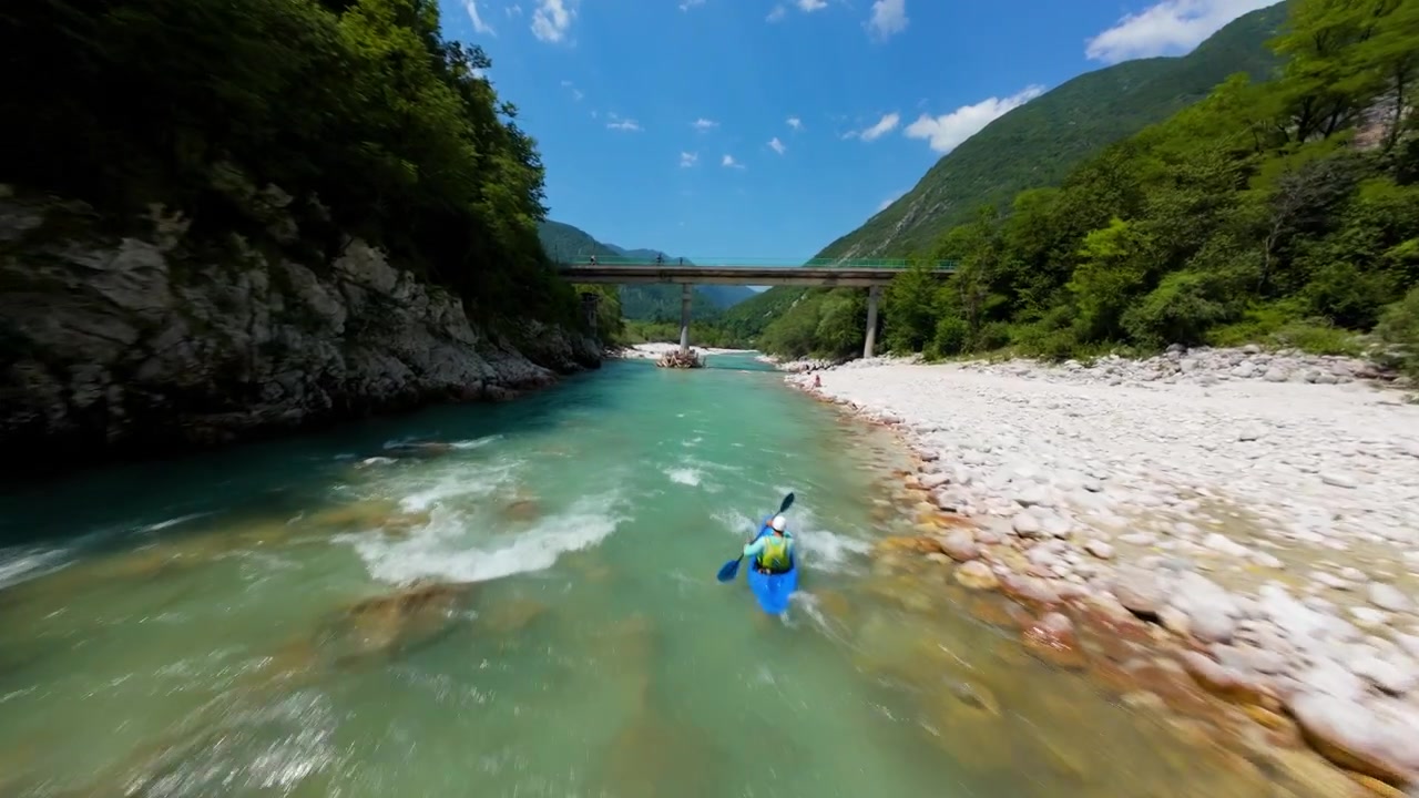 Volo sopra il fiume Isonzo con kayakisti, kayak su acqua verde smeraldo in Slovenia. Ripresa aerea FPV.
