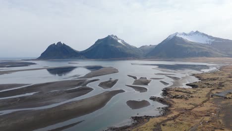 Black-Rivers-Glacial-Mountains,-Iceland-Landscape-Drone-Fly-above-Natural-Earth-skyline,-snowed-peaks,-Aerial-shot