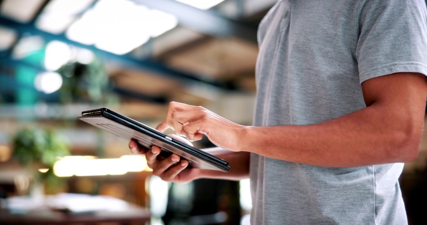 Person Using a Tablet in a Modern Office Setting