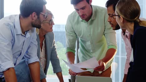 businesspeople interacting over a document