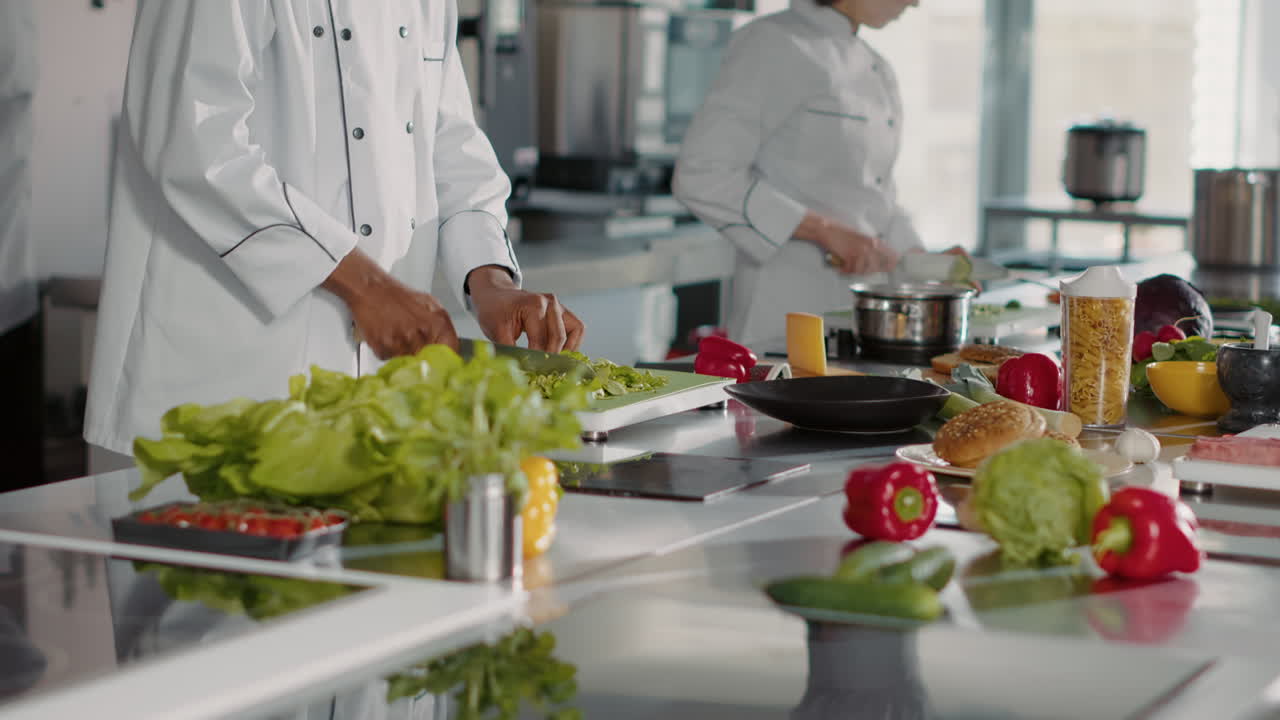 Portrait of african american cook in uniform making meal preparations