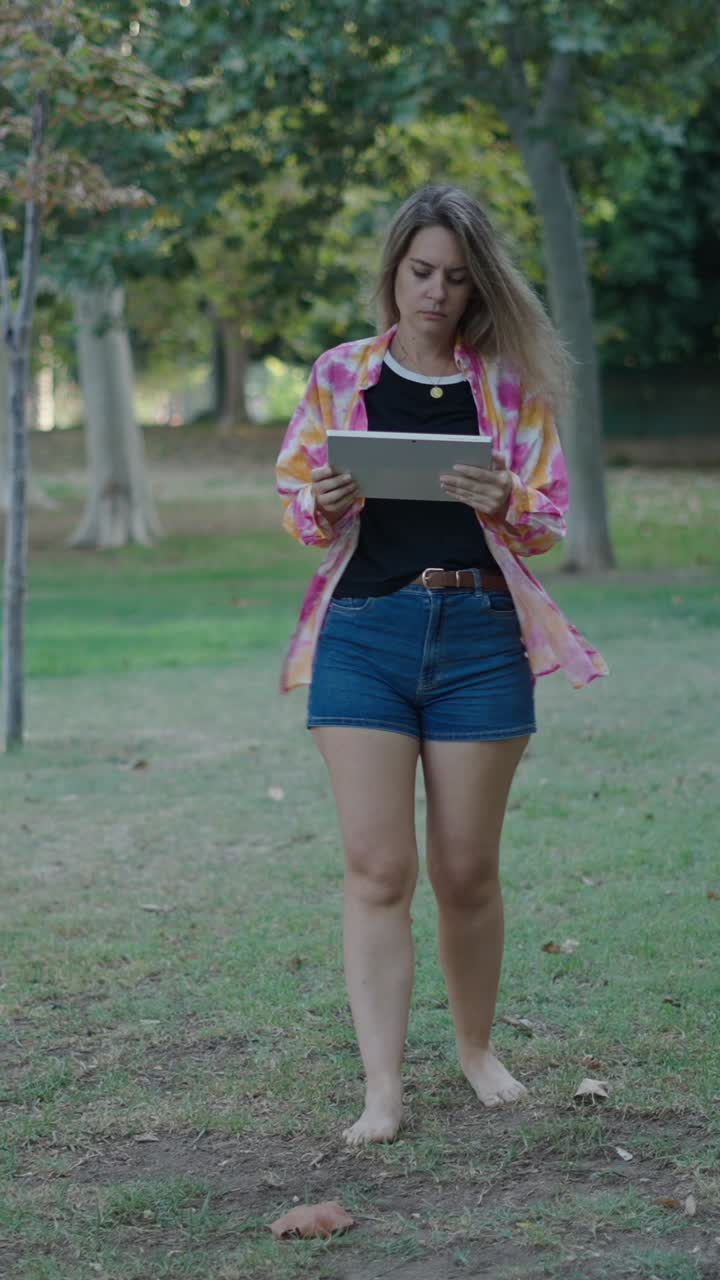 Woman using tablet in park