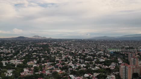 Aerial-hyperlapse-of-the-eastern-part-of-Mexico-City,-with-a-view-of-the-snow-capped-volcanoes