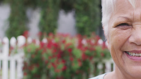 Portrait-of-happy-senior-caucasian-woman-looking-at-camera-in-garden