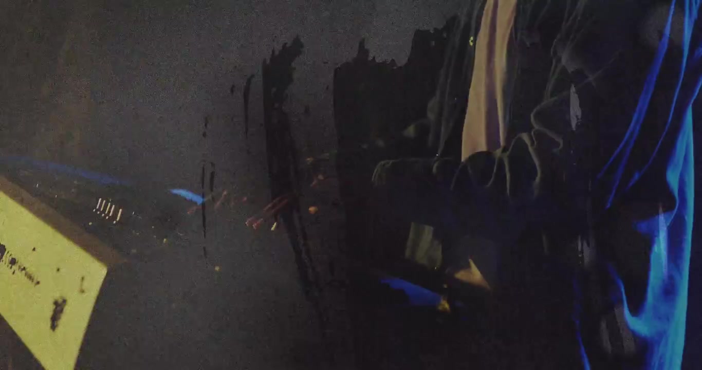 Male musician placing hands on MIDI rig and making music while glitch overlay sweeping across frame