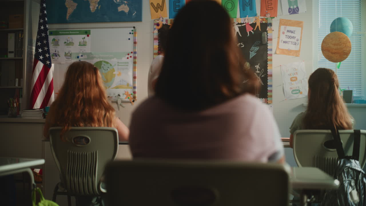 Female Teacher Conducting Lecture on Ecology to Primary School Children in Modern Classroom