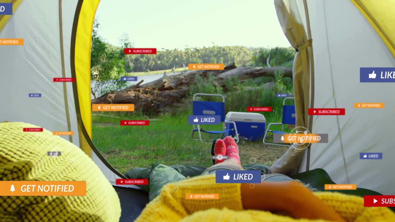 Relaxing by lake, campers receiving social media notifications with animation overlay
