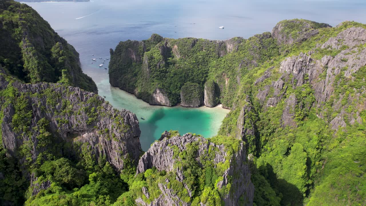 Revealing aerial 4k drone view of Phi Phi Leh, Pileh Lagoon, Krabi province, Thailand. Amazing tropical island with clear turquoise water during a low tide , famous travel destination.
