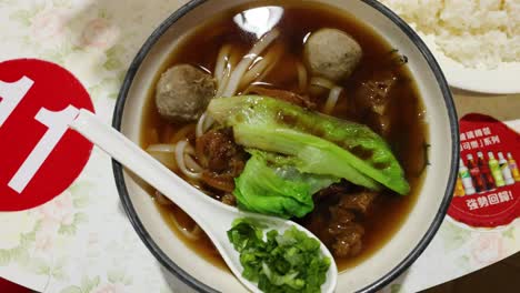 a bowl of beef noodle soup with vegetables