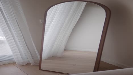 full length arch top mirror in bedroom interior