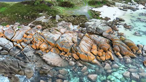 Panning-left-along-the-brightly-coloured-coastline-of-the-Bay-of-Fires