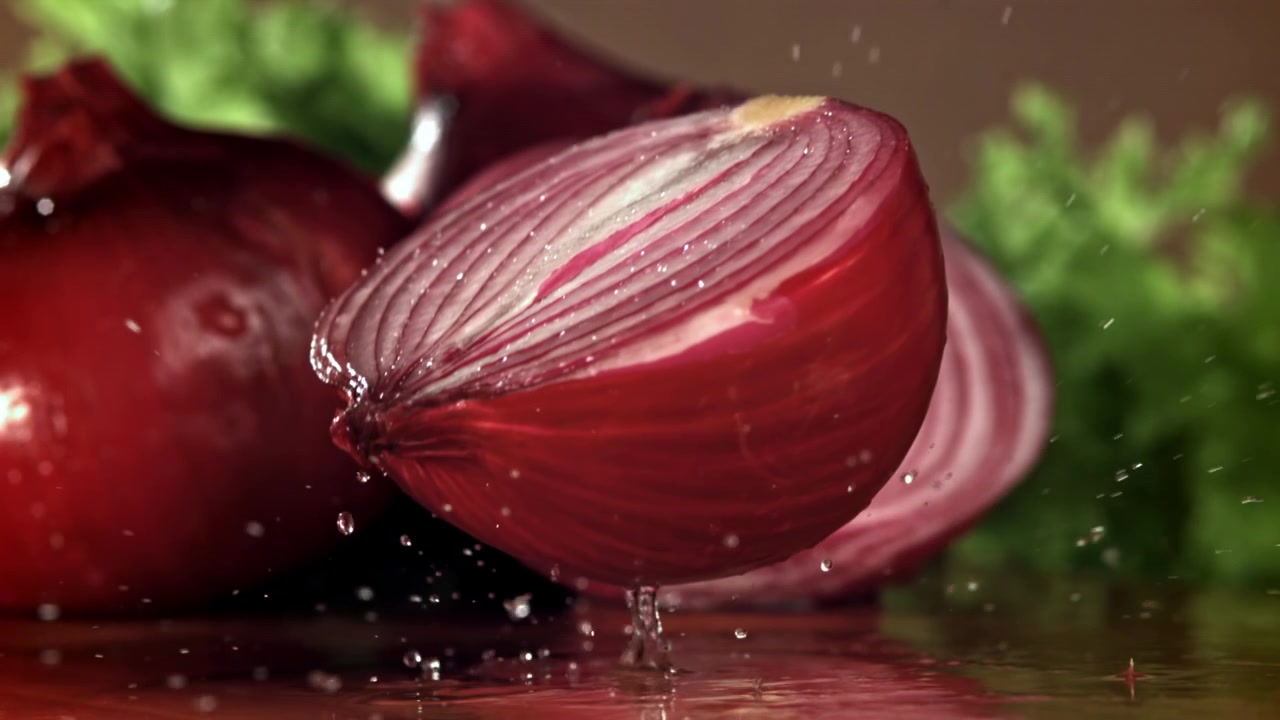 Fresh Red Onion Half with Water Splashing in Slow Motion