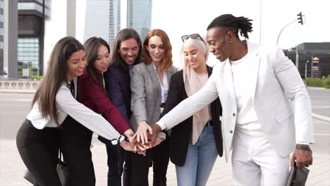 group of business people join hands in the city, multiracial people, coworkers.