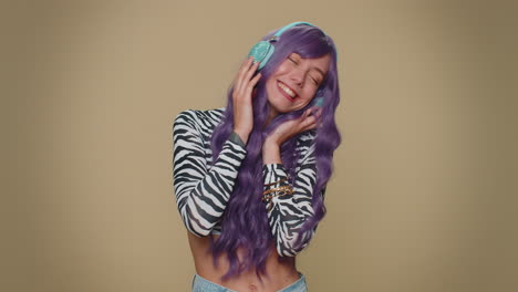 happy pretty relaxed woman listening music on headphones and dancing disco fooling around having fun