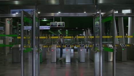 woman walking through a modern train station