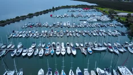 aerial shot of luxury boats moored in tranquil marina on a calm day