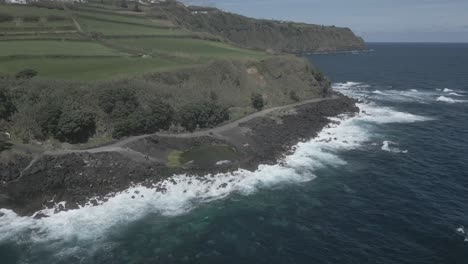 Coastal-road-and-volcanic-rocky-cliffs-of-Santo-Antonio,-Sao-Miguel-of-Azores-islands