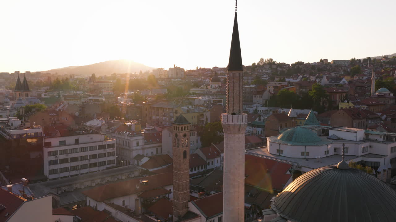 Gazi Husrev-beg Mosque Minaret At Sunset In The City Of Sarajevo, Bosnia and Herzegovina. Aerial Drone Shot
