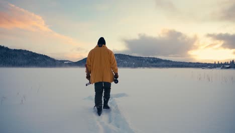 man walking on deep snowy field in indre fosen, norway - wide shot