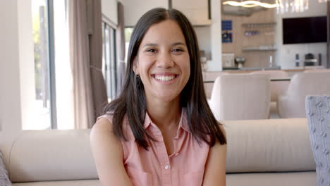 smiling teenage girl sitting on couch, enjoying time at home