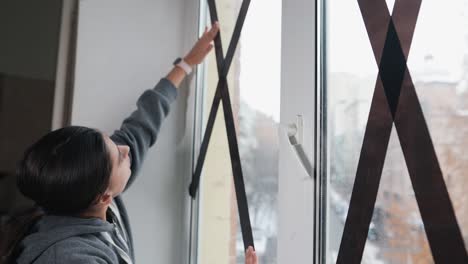 Putting security tape on a window