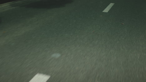 close up shot of white, dashed lines while driving on a highway. slow motion