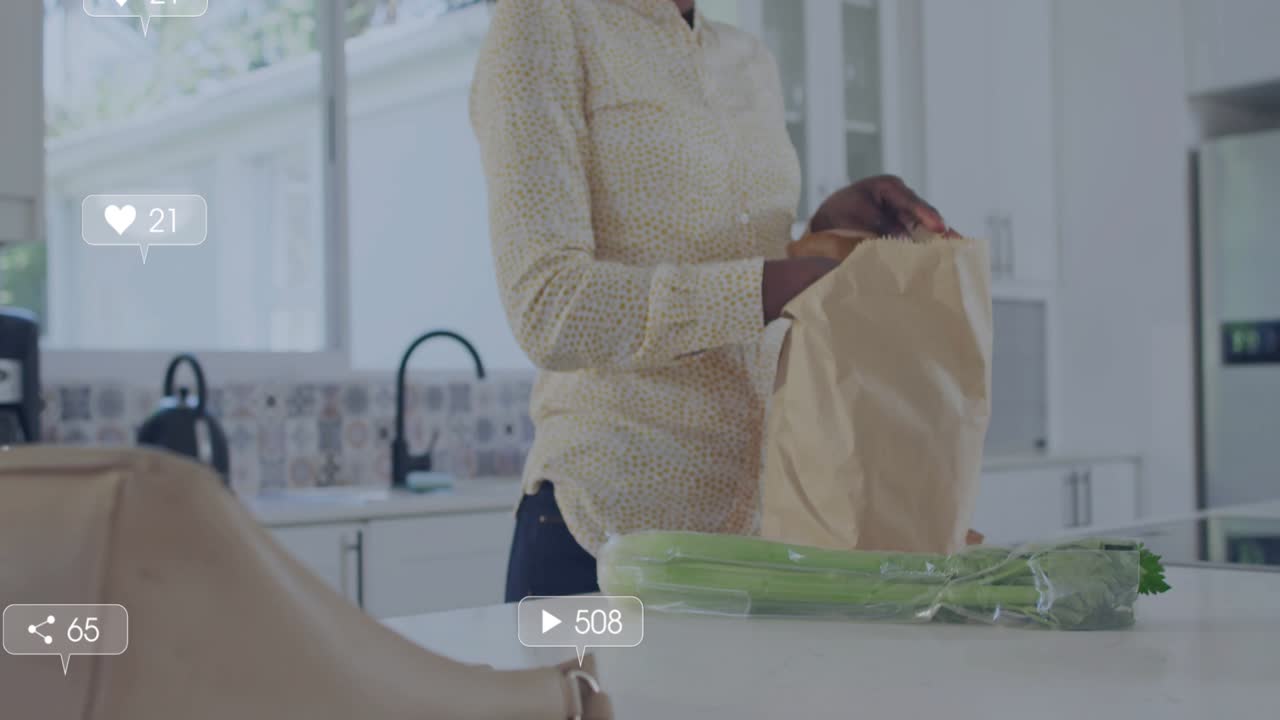 Mid-adult woman unpacking celery on island, phone emitting social metrics, boosting food marketing