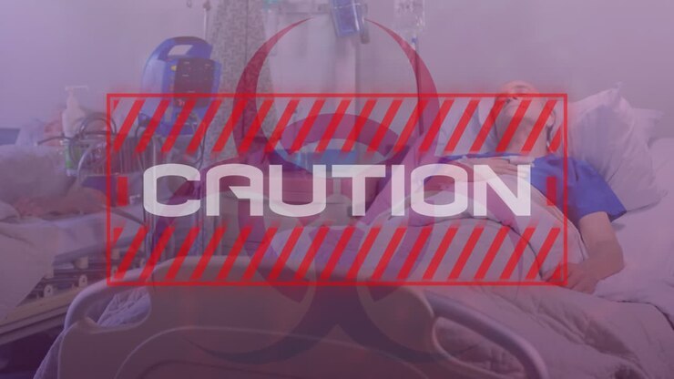 Word Caution written in red frame over a senior male patient. Covid-19 spreading