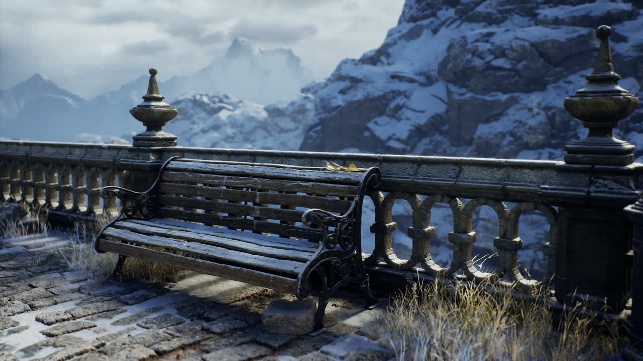 Winter landscape with a rustic bench and snow covered mountains in view