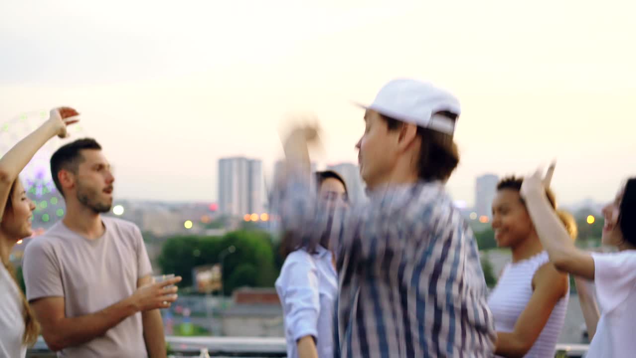 Sudden mood swing of handsome young man hipster standing outside with sad face then dancing happily with friends. Emotional change, partying and people concept.