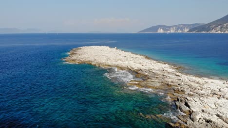 rocky coast and turquoise ocean at paralia emplisi in greece - aerial drone shot