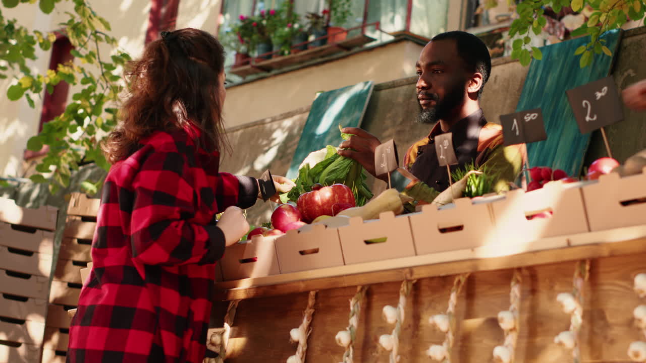 Customer Buying Vegetables at Outdoor Market