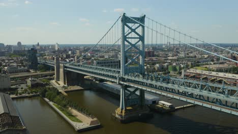 aerial - descent as vehicles cross over bridge in urban location