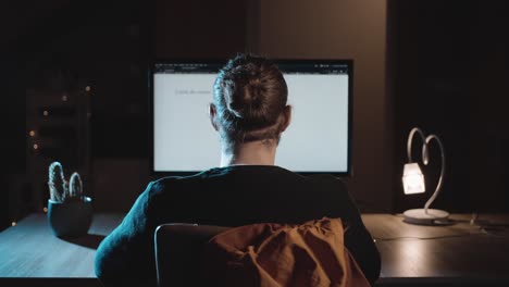 Millennial-Man-with-Bun-Browsing-Web-then-Leaving-Cozy-Tech-Room