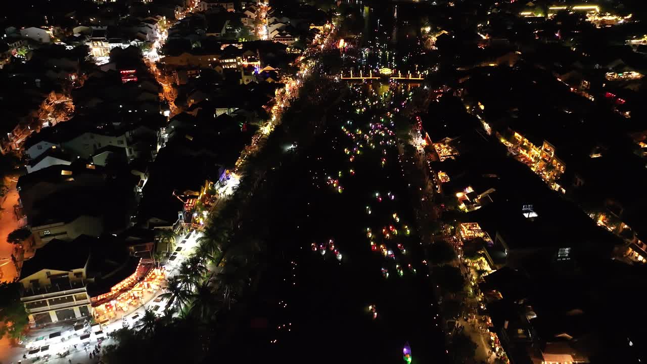 Hoi An at night with colorful boats and festive lights along the river