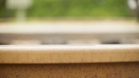 close-up of a rusty rail track with a dolly-in shot, focus on the texture and details, indicating an upcoming journey or travel