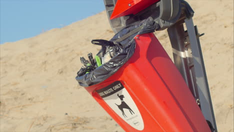 Open-dog-waste-receptacle-on-beach,-close-up