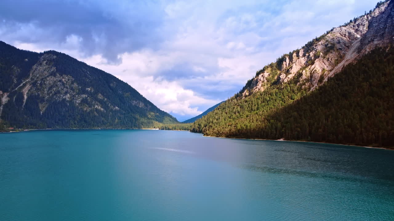 Calm beautiful cityscape of blue lake surrounded by high mountains. Waterscape in Lichtenstein in wild nature.